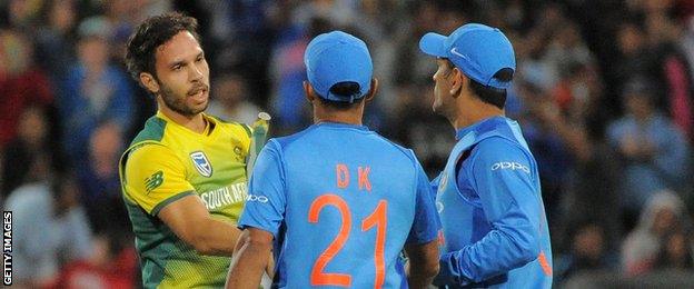 South Africa's Farhaan Behardien shakes hands with India's Dinesh Karthik and MS Dhoni after the T20 series