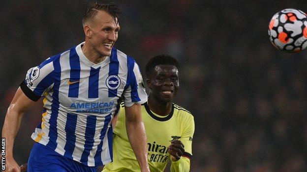 Dan Burn challenging for the ball against Arsenal.