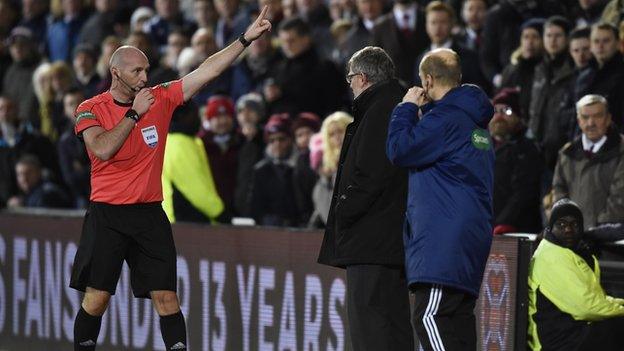 Referee Bobby Madden and Hearts manager Craig Levein