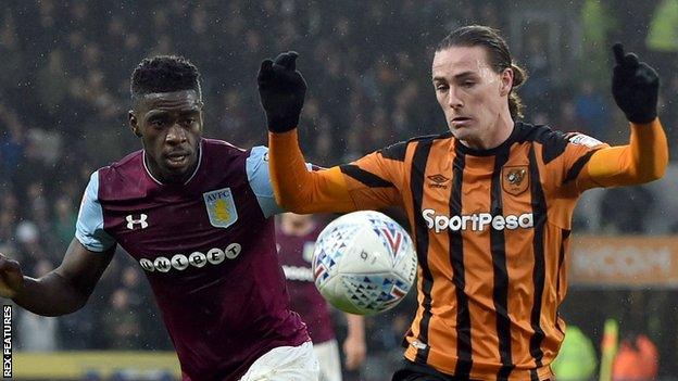 Axel Tuenzebe and Jackson Irvine battle for the ball