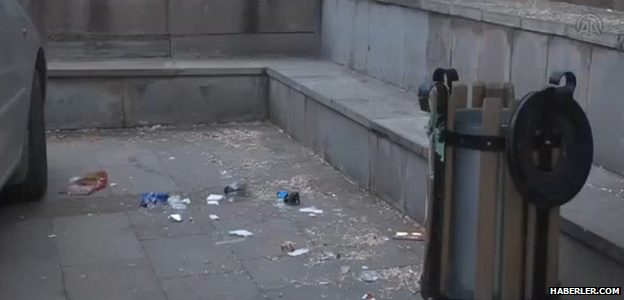 A view of rubbish next to a little bin on the square