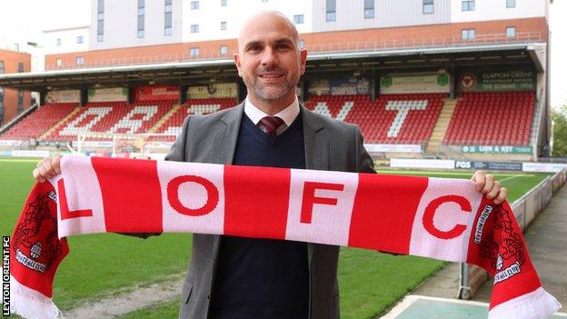 New Leyton Orient head coach Carl Fletcher holds up a club scarf