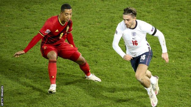 England midfielder Jack Grealish (right) moves the ball away from Belgium midfielder Youri Tielemans (left)