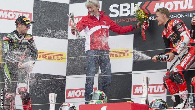 Jonathan Rea and Chaz Davies spray the champagne on the podium