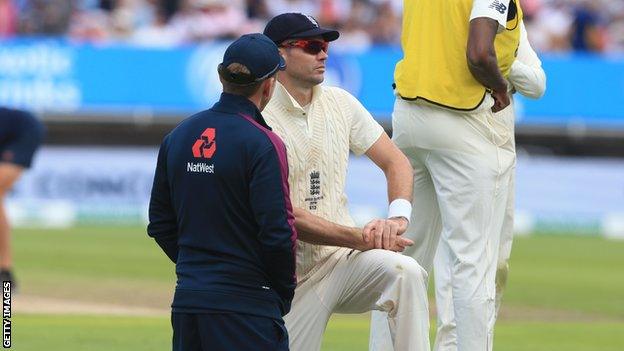 England bowler James Anderson receives treatment from a physio on day one of the first Test against Australia