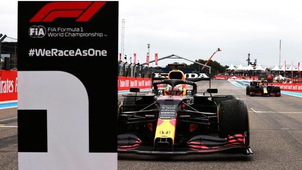 Max Verstappen parks his car by the number one board at park ferme