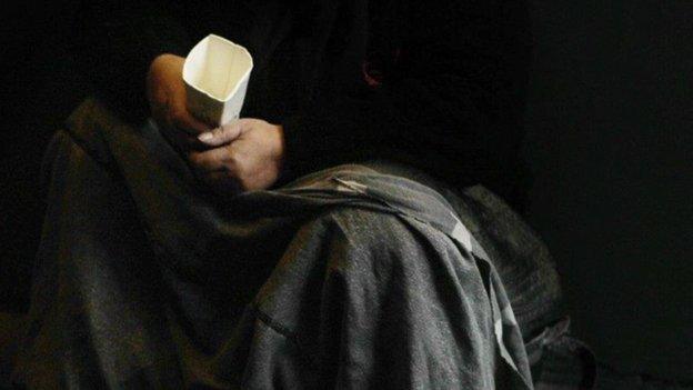 Close up beggar hands with cup