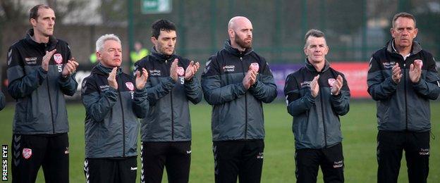 Derry City manager Kenny Shiels (right) and his staff during the minute's applause