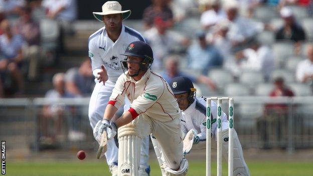 Alex Davies sweeps against Hampshire at Old Trafford, on the way to his third County Championship century this season