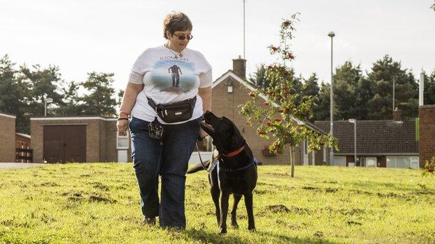 A women walking with her support dog
