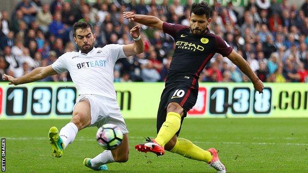 Jordi Amat (left) challenges Manchester City forward Sergio Aguero