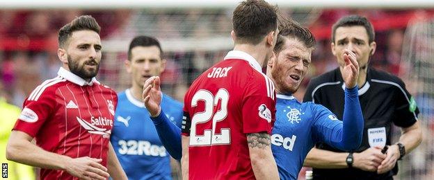 Rangers striker Joe Garner goes down after coming head to head with Ryan Jack