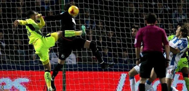 Huddersfield goalkeeper Danny Ward saves from Reading's Lewis Grabban