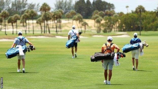 Players carrying their own bags at Seminole Golf Club, Florida