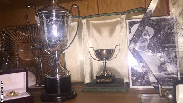 Nancy Richey's small French Open trophy replica sits in a cabinet at her home alongside a grainy newspaper photo of her