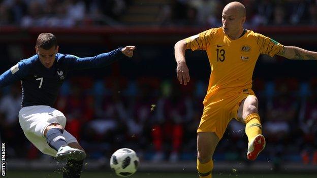 France forward is challenged by Australia midfielder Aaron Mooy