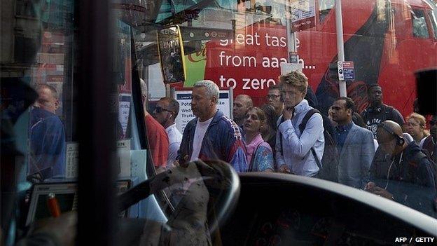 Commuters queue for the bus during 9 July Tube strike