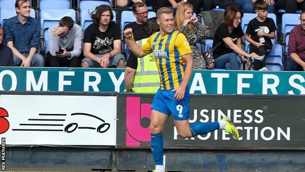 Sam Cosgrove celebrates scoring a goal for Shrewsbury Town