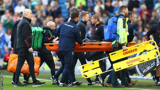 Tino Livramento is stretchered off against Brighton