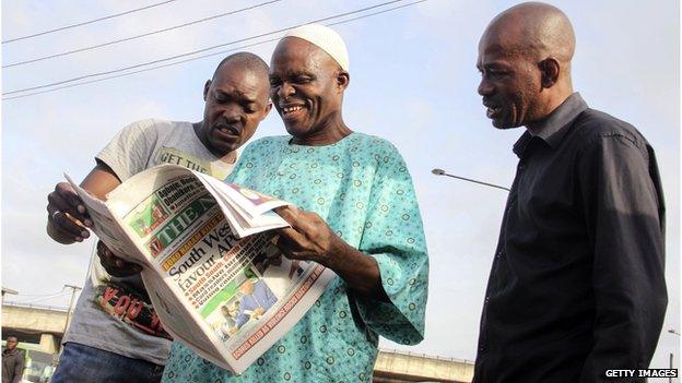 Men in Lagos reading a newspaper