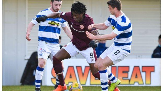 Hearts' Armand Gnanduillet (centre) is closed down by Morton's Stephen McGinn