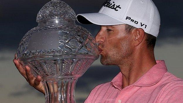 Scott kisses the trophy after edging out Sergio Garcia