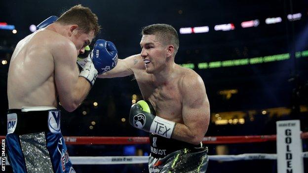 Liam Smith (right) aims a blow at Saul Alvarez