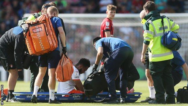 Grant Ward being placed on a stretcher after injury