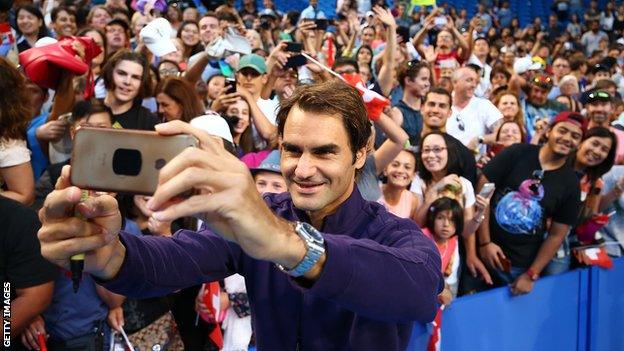 Roger Federer taking a selfie of fans during a Hopman Cup practice session