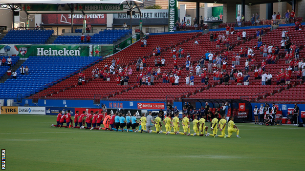 Dallas and Nashville players kneel during the national anthem