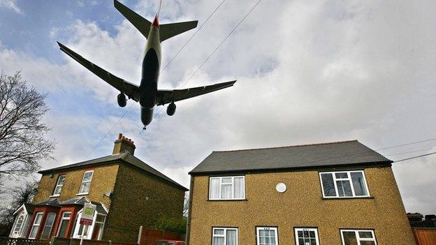 Plane flying over a house