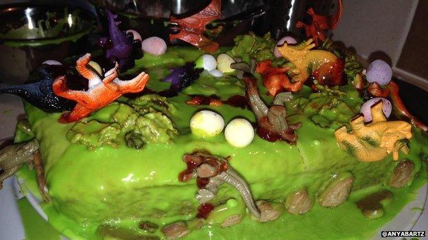 Cake with dinosaur toys all over it