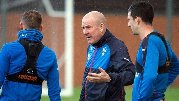 Rangers manager Mark Warburton passes advice during training