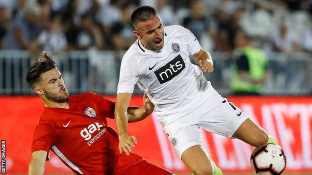 Zoran Tosic (R) of Partizan is challenged by Callum Roberts of (L) Connah's Quay