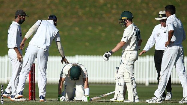 Will Pucovski on his hands ond knees after being struck on the helmet by a bouncer