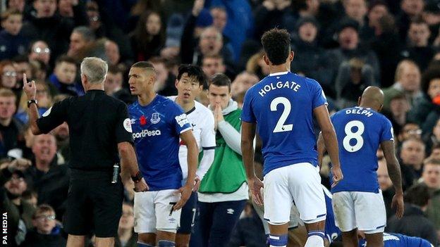 Everton players console Andre Gomes after suffering a serious ankle injury against Tottenham