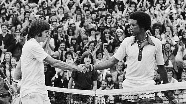 Arthur Ashe (right) shakes hands with Jimmy Connors at the net after the 1975 Wimbledon final