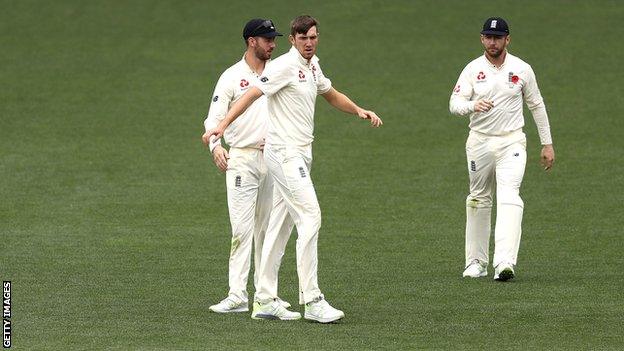 England's Craig Overton (centre) celebrates after taking the wicket of Matthew Short during day four.