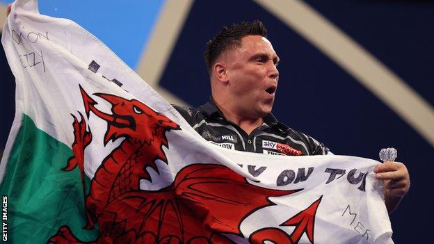 Gerwyn Price celebrated victory by waving the Welsh flag at Alexandra Palace