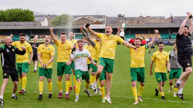 Caernarfon players and staff celebrate their victory