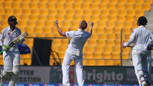 Ben Stokes (centre) takes the wicket of Mohammad Hafeez (left)