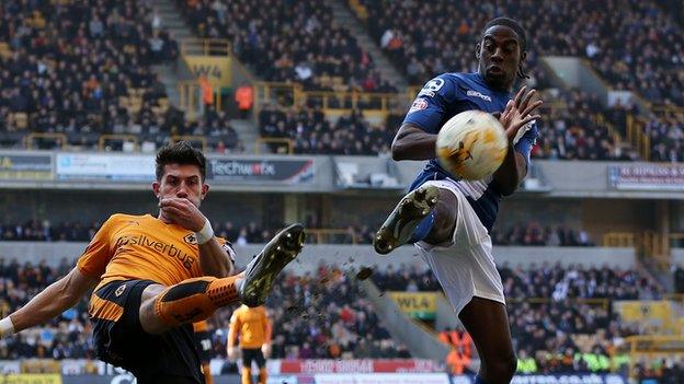 Wolves captain Danny Batth clears under pressure from Clayton Donaldson