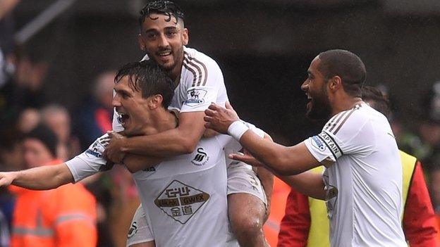 Jack Cork, Neil Taylor and Ashley Williams celebrate a Swansea goal