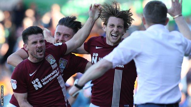 Ash Taylor celebrates a goal for Northampton