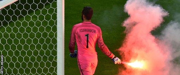 Turkey goalkeeper Volkan Babacan had to remove a flare after his country scored a second