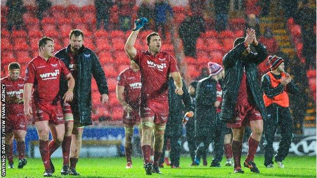 Scarlets celebrate their win at a rain-lashed Parc y Scarlets