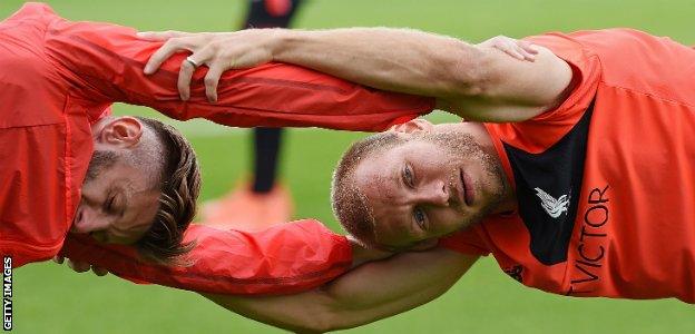 Ragnar Klavan warms up with Adam Lallana