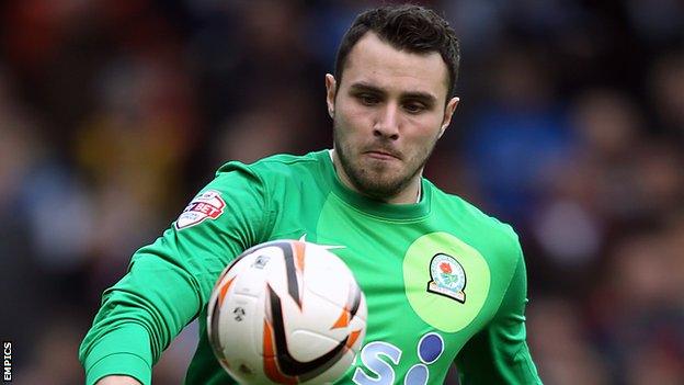 Jake Kean watches the ball onto his boot for Blackburn against Blackpool