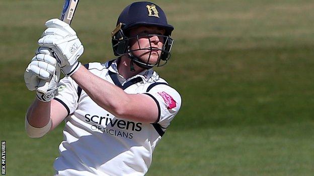 Warwickshire's Rob Yates hits a six against Essex