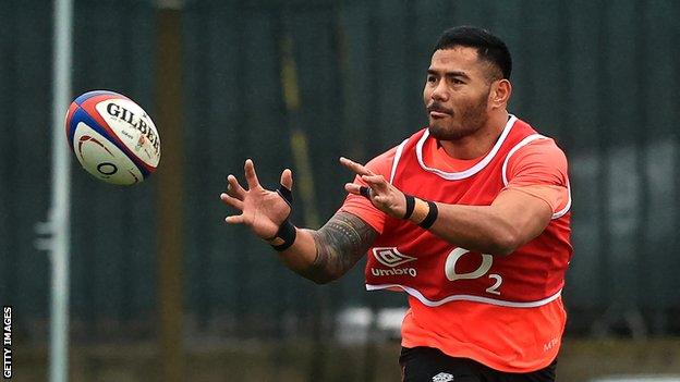 England rugby player Manu Tuilagi prepares to catch a pass in training